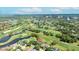 Aerial perspective showcases the golf course, ponds, city skyline and home location at 2900 Sandpiper Pl, Clearwater, FL 33762