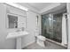 Modern bathroom with sleek glass shower, pedestal sink and tile floors at 2900 Sandpiper Pl, Clearwater, FL 33762