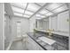Bright bathroom featuring granite counters, modern fixtures, and a glass-enclosed shower for a luxurious feel at 2900 Sandpiper Pl, Clearwater, FL 33762