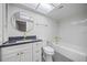 Well-lit bathroom features a shower and tub with gold fixtures and granite counters at 2900 Sandpiper Pl, Clearwater, FL 33762