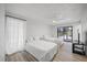 Bright bedroom with hardwood floors, sliding glass door to backyard, and neutral decor at 2900 Sandpiper Pl, Clearwater, FL 33762