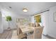 Dining room features a large table, wicker chairs, neutral tones, and natural lighting at 2900 Sandpiper Pl, Clearwater, FL 33762