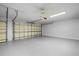 Spacious two car garage with neutral walls and floor and an electric garage door opener at 2900 Sandpiper Pl, Clearwater, FL 33762
