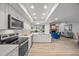 Modern kitchen with stainless steel appliances, white cabinetry, and an open layout at 2900 Sandpiper Pl, Clearwater, FL 33762