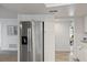 Modern kitchen features stainless steel refrigerator and white cabinets for a clean aesthetic at 2900 Sandpiper Pl, Clearwater, FL 33762