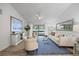 Bright living room features a high ceiling, wood floors, and seamless indoor-outdoor flow at 2900 Sandpiper Pl, Clearwater, FL 33762