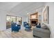 Living room showcasing a brick fireplace, ceiling fan, and seamless access to the screened patio at 2900 Sandpiper Pl, Clearwater, FL 33762