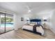 Main bedroom offering pool access and a ceiling fan for added comfort and convenience at 2900 Sandpiper Pl, Clearwater, FL 33762