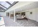 Covered patio with pavers, lounge chairs, and an outdoor bar, perfect for relaxation and entertaining at 2900 Sandpiper Pl, Clearwater, FL 33762