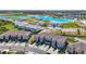 Stunning aerial view of the townhomes in a community with a lagoon and resort-style amenities at 31771 Blue Passing Loop, Wesley Chapel, FL 33545