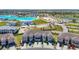 Stunning aerial view of a townhome community with a lagoon at 31771 Blue Passing Loop, Wesley Chapel, FL 33545