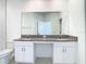 Spacious bathroom with double sinks, granite countertops, white cabinets, and modern fixtures at 31771 Blue Passing Loop, Wesley Chapel, FL 33545
