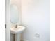 Bathroom featuring a pedestal sink and oval mirror at 31771 Blue Passing Loop, Wesley Chapel, FL 33545