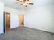 Neutral bedroom with open doorway and an ensuite bathroom and neutral carpeting at 31771 Blue Passing Loop, Wesley Chapel, FL 33545