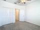 Bedroom with closet, ceiling fan and gray carpet at 31771 Blue Passing Loop, Wesley Chapel, FL 33545