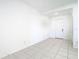 Simple bedroom with tile flooring and a single door at 31771 Blue Passing Loop, Wesley Chapel, FL 33545