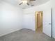 Neutral bedroom featuring bi-fold closet doors and carpet floors at 31771 Blue Passing Loop, Wesley Chapel, FL 33545
