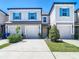Beautiful townhome featuring a garage, well-manicured landscaping, and modern design at 31771 Blue Passing Loop, Wesley Chapel, FL 33545