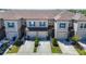 Charming townhome featuring a two-car garage and attractive landscaping at 31771 Blue Passing Loop, Wesley Chapel, FL 33545