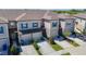 Beautiful townhome featuring a garage, well-manicured landscaping, and modern design at 31771 Blue Passing Loop, Wesley Chapel, FL 33545