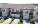 Beautiful townhome featuring a garage, well-manicured landscaping, and modern design at 31771 Blue Passing Loop, Wesley Chapel, FL 33545