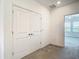 Hallway with carpet and white double door closet at 31771 Blue Passing Loop, Wesley Chapel, FL 33545