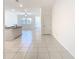 Bright kitchen featuring tile flooring, island with sink and open floor plan at 31771 Blue Passing Loop, Wesley Chapel, FL 33545