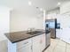 Open concept kitchen island with granite countertop and stainless steel dishwasher at 31771 Blue Passing Loop, Wesley Chapel, FL 33545
