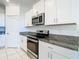 Well-equipped kitchen with stainless steel appliances and granite countertops at 31771 Blue Passing Loop, Wesley Chapel, FL 33545