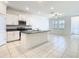 Modern kitchen with white cabinetry, stainless appliances, and center island at 31771 Blue Passing Loop, Wesley Chapel, FL 33545