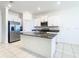 Open floor plan showcasing modern kitchen with stainless steel appliances and island at 31771 Blue Passing Loop, Wesley Chapel, FL 33545