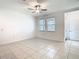 Open concept living room featuring neutral walls, tile floor, and a ceiling fan at 31771 Blue Passing Loop, Wesley Chapel, FL 33545