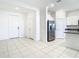Open-concept living area with tile flooring and white walls at 31771 Blue Passing Loop, Wesley Chapel, FL 33545