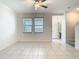Bright living room features tile flooring, ceiling fan, and windows for natural light at 31771 Blue Passing Loop, Wesley Chapel, FL 33545