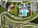 Stunning aerial view of community pool, playground, and clubhouse with ample parking at 35100 Brackett Bnd, Zephyrhills, FL 33541