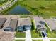 Aerial view of a well-manicured home with a lush green lawn and driveway at 35100 Brackett Bnd, Zephyrhills, FL 33541