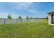 Expansive backyard with lush lawn and white privacy fence, offering ample space at 35100 Brackett Bnd, Zephyrhills, FL 33541