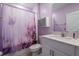 Charming bathroom with lilac walls, a shower, and a white vanity at 35100 Brackett Bnd, Zephyrhills, FL 33541