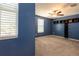 Spacious bedroom featuring a ceiling fan, built-in shelving, and large windows providing plenty of natural light at 35100 Brackett Bnd, Zephyrhills, FL 33541