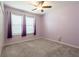 Bedroom with carpet, a ceiling fan, and windows with purple curtains at 35100 Brackett Bnd, Zephyrhills, FL 33541