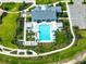An aerial view of a resort-style community pool with ample seating and lush landscaping at 35100 Brackett Bnd, Zephyrhills, FL 33541