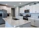 Modern kitchen featuring an island with a sink, stainless steel appliances, and white cabinets at 35100 Brackett Bnd, Zephyrhills, FL 33541