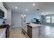 Modern kitchen features an island with a sink, stainless steel appliances, and a gas range at 35100 Brackett Bnd, Zephyrhills, FL 33541