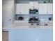 Modern kitchen featuring an island with a sink, stainless steel appliances, and white cabinets at 35100 Brackett Bnd, Zephyrhills, FL 33541