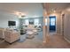 Bright living room featuring a white sofa set, contemporary decor, and neutral walls at 35100 Brackett Bnd, Zephyrhills, FL 33541