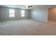 Large living area with carpet, a ceiling fan, and lots of natural light at 35100 Brackett Bnd, Zephyrhills, FL 33541