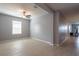 Open living area with tile flooring, a ceiling fan, and natural light from a large window at 35100 Brackett Bnd, Zephyrhills, FL 33541