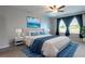 Comfortable bedroom featuring a large bed, ceiling fan, cool colors, and natural light at 35100 Brackett Bnd, Zephyrhills, FL 33541