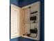 Home media panel with neatly arranged wiring, power strip, and connections for seamless smart home integration at 35100 Brackett Bnd, Zephyrhills, FL 33541