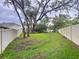 Large backyard with mature trees and white fencing offers privacy at 3544 Brook Crossing Dr, Brandon, FL 33511